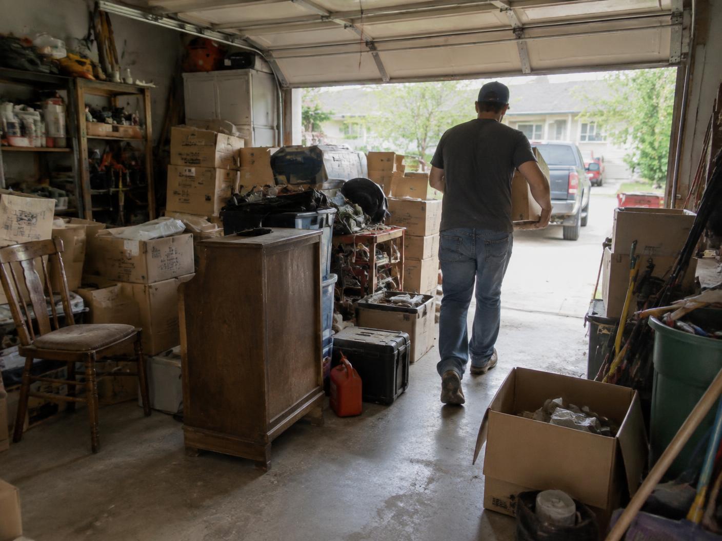 Cluttered residential garage being cleared during a junk removal job
